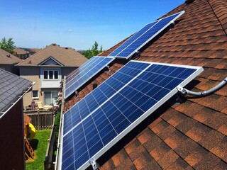 Side view at solar panels on residential roof in Ontario, Canada. Production of solar panels. Green energy concept.