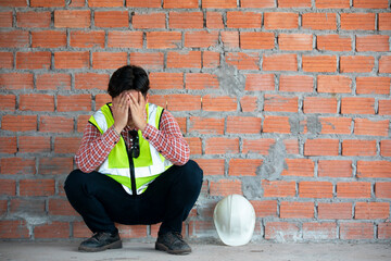  Distraught Construction Worker the hands on his face on brick wall background texture. engineer...