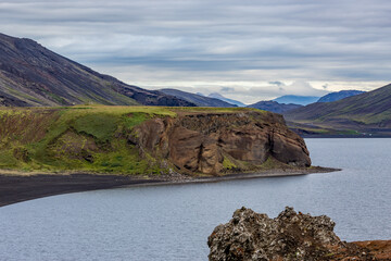 Volcanic lake landscape, Southern Iceland, cloudy sky in a warm summer August day, contrast and curves. Such a photogenic travel destination!
