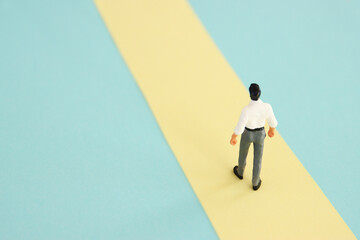 Fototapeta na wymiar Concept image of man walking on pathway, moving forward
