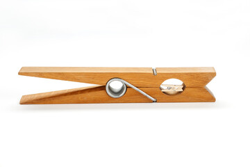 Small wooden clothespin in a big wooden clothespin  on a white background