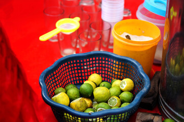 lemons,glasses,salt,filter and squeeger on moble cart of Indian street vendor selling lemonade ,on road