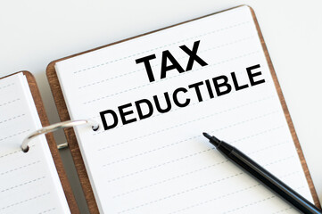 Text Tax Deductions on notepad over white background