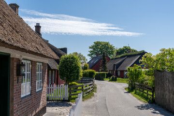 Fototapeta na wymiar picturesque village street with colorful Danish houses in Nordby on Fano Island