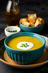 Bowl with pumpkin soup on the table.