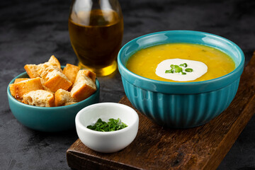 Bowl with pumpkin soup on the table.