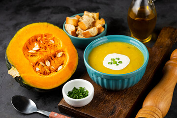 Bowl with pumpkin soup on the table.