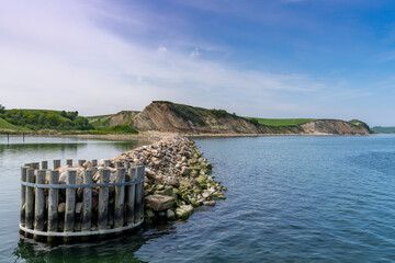harbor jetty and beautiful green seaside cliffs on the shores of the North Sea © makasana photo
