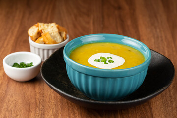 Bowl with pumpkin soup on the table.