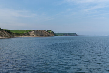 beautiful seaside landscape with cliffs and green meadows on the shore © makasana photo