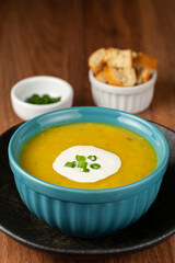 Bowl with pumpkin soup on the table.