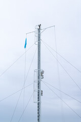 detail view of the cables and mast on a modern car ferr under a cloudy and expressive sky