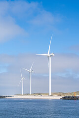 wind turbines on the coast of western Denmark under a blue sky