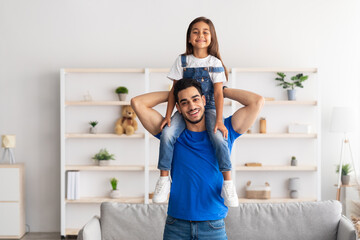 Cheerful Arab Man Riding Excited Daughter On His Shoulders