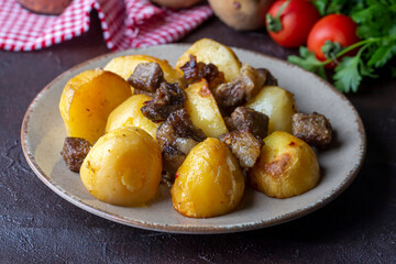 From traditional delicious Turkish food; potato and meat dish in casserole (Turkish name; Guvec tas kebabi, tandir)