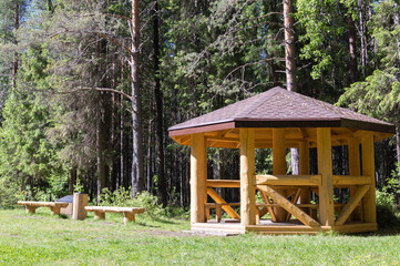 Gazebo in the summer forest.