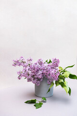Still life scene with a bouquet of lilacs. Minimal composition with flowers, copy space.