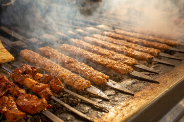 Traditional delicious Turkish food; Adana kebab while cooking on a barbecue