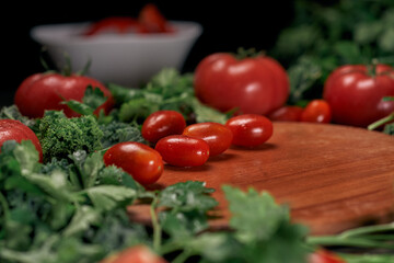 background image of tomatoes on a wooden kitchen board.