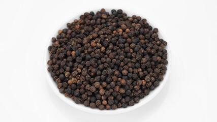 black pepper isolated on white background. Flavorful and aromatic peppercorn. Pile of dried black peppercorns