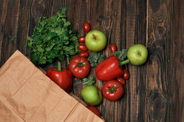 paper bag of vegetables on a wooden table .