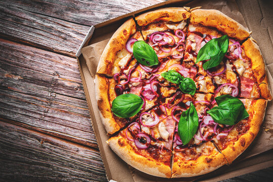 Pizza with chicken and barbeque sauce . Italian pizza on wooden table background