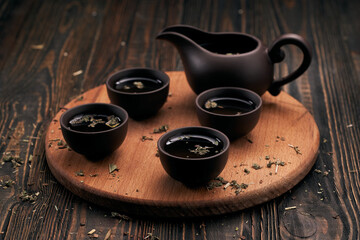 tea set and tea leaves on wooden kitchen board.