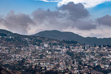 city urbanization view from hilltop with huge construction and dramatic sky