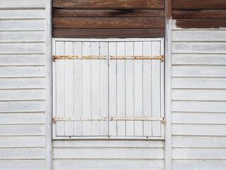 White wooden facade in French West Indies colonial house. Old wooden wall concrete. Wood slat...