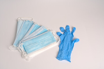 A pack of medical masks on a white background. Space for the text. And a medical glove