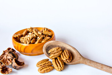 Pecan nuts shelled on white background.
