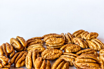 Pecan nuts shelled on white background.