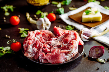 Fresh pork with vegetables on dark background. Fresh meat kitchen