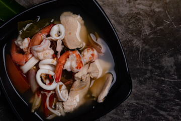 Tom Yum, Clear Soup, Chicken, Shrimp, Squid, popular Thai food mixed boiled lime, chili, mushroom, lemongrass, herbs