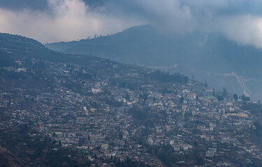 city urbanization view from hilltop with huge construction at day from flat angle