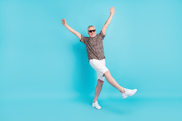 Full length photo of cheerful happy old man raise hands positive mood isolated on pastel blue color background