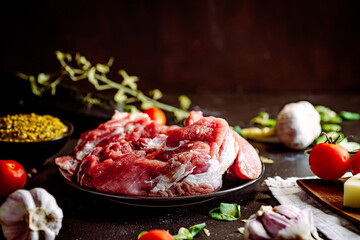 Fresh pork with vegetables on dark background. Fresh meat kitchen - obrazy, fototapety, plakaty