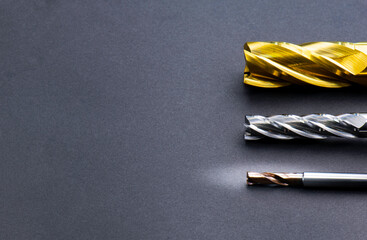 endmill cutting tools special set horizontal, 4 teeth. spiral right hand. material Carbide and high speed steel, coating Titanium nitride. isolated on black background.