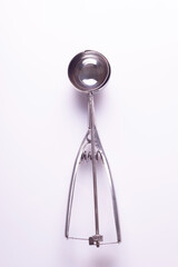metal spoon for ice cream to form balls on a white background