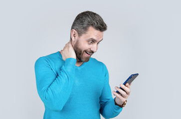 surprised man with beard reading message on smartphone, short message