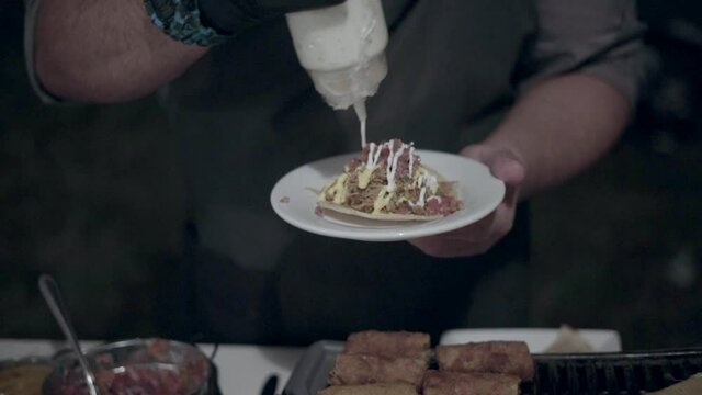 chef colocando salsa a una ensalada mexicana en un restaurante