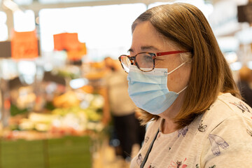 Woman with mask in supermarket.