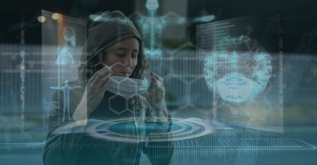 Composition of medical data processing over caucasian woman putting face mask on