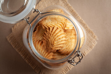 Close-up of delicious freshly baked simple cookies or biscuits  in glass airtight containers.