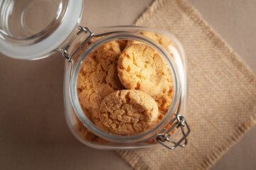 Close-up of delicious freshly baked simple cookies or biscuits  in glass airtight containers.