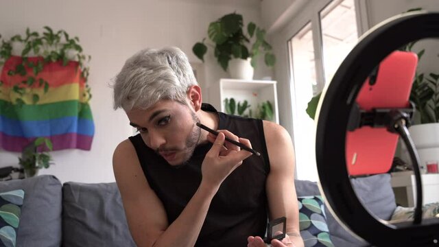 Gay guy performing live video on makeup, concept sharing knowledge of makeup.