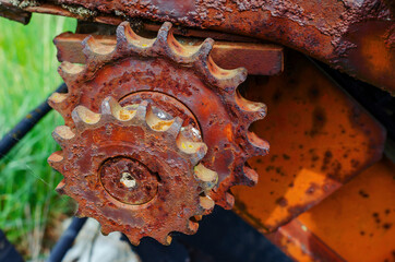 Rusty old metal gears in a broken combine unit