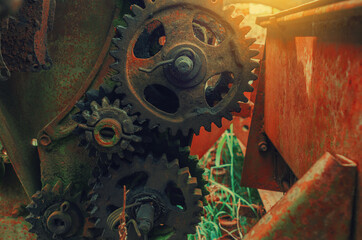 Rusty old metal gears in a broken combine unit