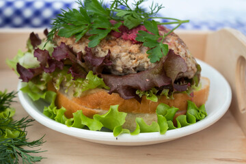 a sandwich with salad and cutlet