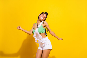 Photo of cheerful joyful dark skin young woman dance happy funky lady isolated on shine yellow color background